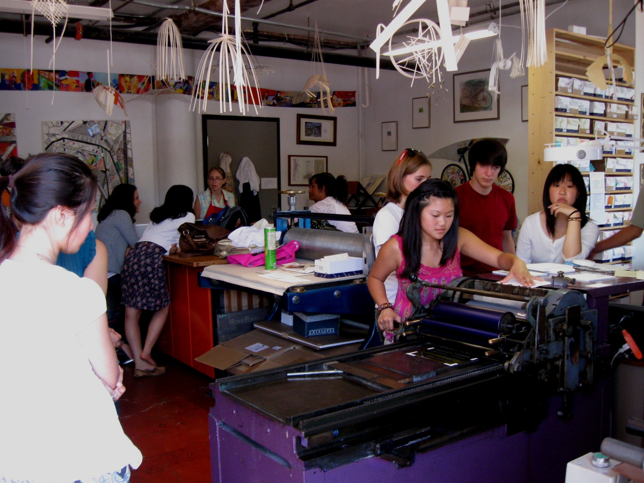 Painted Tongue Press teeming with teens! Students divided into three groups, one at the Vandercook, one at the Heidelberg, and one at the computers.
